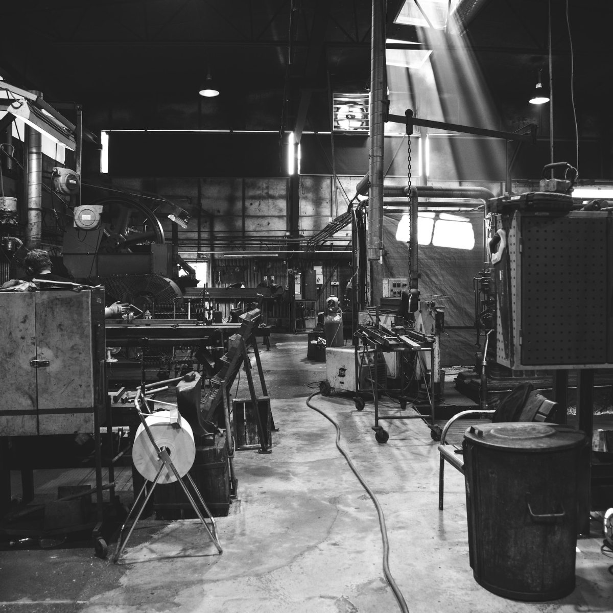 Industrial workshop with machinery and light falling through the windows